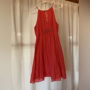 Bright pink a-line dress with beaded detail at waist